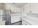 Updated kitchen boasts new stainless-steel appliances, white cabinets, and quartz countertops at 204 Breeze St, Las Vegas, NV 89145
