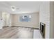 Spacious living room with fireplace, large window, and wood flooring at 204 Breeze St, Las Vegas, NV 89145