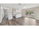 Open-concept living room with hardwood floors and access to the kitchen and outdoor space at 204 Breeze St, Las Vegas, NV 89145