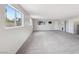 Spacious living room featuring neutral walls, carpeted flooring, and lots of natural light at 204 Breeze St, Las Vegas, NV 89145