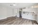 Open-concept living area featuring wood-look floors and a breakfast bar connected to the kitchen at 204 Breeze St, Las Vegas, NV 89145