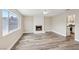 Inviting living room features a large window and white brick fireplace, with new wood floors at 204 Breeze St, Las Vegas, NV 89145