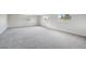 Spacious living room featuring neutral walls, carpeted flooring, and lots of natural light at 204 Breeze St, Las Vegas, NV 89145