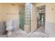 Bathroom showcasing toilet, glass block divider, and walk-in shower at 2486 Sabado St, Las Vegas, NV 89121