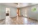 Large bedroom featuring tile floors, ceiling fan, and access to bathroom and backyard at 2486 Sabado St, Las Vegas, NV 89121