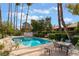 Community pool with lounge chairs and dining tables at 2486 Sabado St, Las Vegas, NV 89121