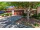 Charming townhome featuring a private garage, quaint landscaping and a terra cotta tiled roof at 2486 Sabado St, Las Vegas, NV 89121