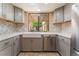 Stylish kitchen featuring stainless appliances, tile backsplash, and a sink with backyard views at 2486 Sabado St, Las Vegas, NV 89121