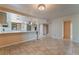 Open-concept kitchen with stainless appliances, updated cabinets, and a breakfast bar at 2486 Sabado St, Las Vegas, NV 89121