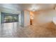 Bright living room with tile flooring, a ceiling fan, and a large sliding glass door to a patio at 2486 Sabado St, Las Vegas, NV 89121