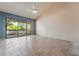 Spacious living room with tile flooring, vaulted ceiling, and sliding door access to patio at 2486 Sabado St, Las Vegas, NV 89121