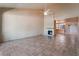 Spacious living room with tile flooring, vaulted ceiling, fireplace, and access to the kitchen at 2486 Sabado St, Las Vegas, NV 89121