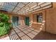 Enclosed back patio featuring a covered trellis, lush landscaping, and lots of natural light at 2486 Sabado St, Las Vegas, NV 89121