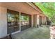 View of covered patio with sliding glass doors and landscaped brick planter at 2486 Sabado St, Las Vegas, NV 89121