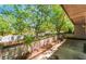 Outdoor patio area showcasing brick planter with landscaping and mature shade trees at 2486 Sabado St, Las Vegas, NV 89121