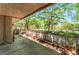 Covered outdoor patio area with brick planter and mature landscaping provides private space at 2486 Sabado St, Las Vegas, NV 89121