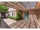 Enclosed back patio featuring lush landscaping, a covered trellis, and lots of natural light at 2486 Sabado St, Las Vegas, NV 89121