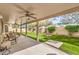 Picturesque backyard featuring artificial turf, a covered patio, and scenic landscaping, perfect for relaxing and entertaining at 2561 Pyramid Pines Dr, Henderson, NV 89052
