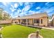 Enjoy this beautiful backyard with green artificial turf, covered patio, providing a private and relaxing outdoor retreat at 2561 Pyramid Pines Dr, Henderson, NV 89052