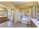 Stylish bathroom featuring a glass shower, soaking tub, and a spacious vanity area with mirror at 2561 Pyramid Pines Dr, Henderson, NV 89052