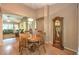 Warm dining area with a round table, wood floors, and views into the living room at 2561 Pyramid Pines Dr, Henderson, NV 89052