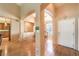 Open entryway with archways, wood floors, and views of the kitchen and dining areas at 2561 Pyramid Pines Dr, Henderson, NV 89052