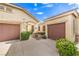 Paired garages give this home plenty of parking, the landscaped entry leads to a cozy desert home at 2561 Pyramid Pines Dr, Henderson, NV 89052