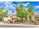 Inviting single-story home with a well-maintained desert landscape, mature trees, and a two-car garage at 2561 Pyramid Pines Dr, Henderson, NV 89052