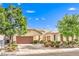 Charming single-story home with desert landscaping, mature trees, and a two-car garage at 2561 Pyramid Pines Dr, Henderson, NV 89052