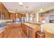 Well-lit kitchen featuring wooden cabinets, granite countertops, and stainless steel appliances at 2561 Pyramid Pines Dr, Henderson, NV 89052