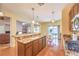 Bright kitchen features granite countertops, wood cabinets, pendant lighting and stainless steel appliances at 2561 Pyramid Pines Dr, Henderson, NV 89052