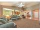 Open-concept living room flows into kitchen and dining areas, featuring vaulted ceilings and neutral tones at 2561 Pyramid Pines Dr, Henderson, NV 89052