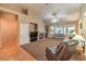 Cozy living room with vaulted ceilings, a fireplace, and carpeted floors for comfortable living at 2561 Pyramid Pines Dr, Henderson, NV 89052