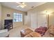 Comfortable living area with a leather couch, TV, and carpet flooring, ideal for relaxing and entertaining at 2561 Pyramid Pines Dr, Henderson, NV 89052