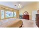 Bright main bedroom includes a large window, neutral carpet, and classic wood furniture at 2561 Pyramid Pines Dr, Henderson, NV 89052