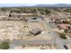 Bird's eye view of home with large lot, desert landscape, and nearby road in rural area at 2571 N David St, Pahrump, NV 89060
