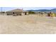 Desert home features a spacious backyard with desert landscaping, providing an open, natural setting at 2571 N David St, Pahrump, NV 89060