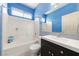 Bright bathroom with white tiled shower/tub, vanity, and large mirror at 2571 N David St, Pahrump, NV 89060