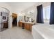 Large bathroom featuring dual sinks, a soaking tub, and a view to the backyard, promising relaxation at 2571 N David St, Pahrump, NV 89060