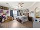 Well-lit bedroom featuring wood floors, ceiling fan, and a comfortable atmosphere, creating an inviting space at 2571 N David St, Pahrump, NV 89060