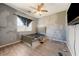 Spacious bedroom featuring unfinished wall paint, ceiling fan, and natural light from the window at 2571 N David St, Pahrump, NV 89060