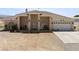Charming single-story home with desert landscaping, covered porch, and two-car garage at 2571 N David St, Pahrump, NV 89060