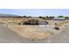 Single-story home with covered porch, desert landscape, and a two-car garage on expansive lot at 2571 N David St, Pahrump, NV 89060