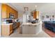 Functional kitchen with wood cabinets, stainless steel appliances, and a breakfast bar, ideal for meal preparation at 2571 N David St, Pahrump, NV 89060