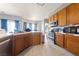 Well-lit kitchen featuring stainless steel appliances, tiled floor, and ample wooden cabinet space at 2571 N David St, Pahrump, NV 89060