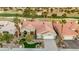 This aerial view features a house with a tile roof, well manicured yard and views of the golf course at 2621 Spalding Dr, Las Vegas, NV 89134