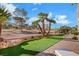 The backyard shows desert landscaping with rocks, palm trees, and artificial turf at 2621 Spalding Dr, Las Vegas, NV 89134