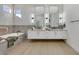 Modern bathroom featuring a soaking tub, double vanity sinks, and plenty of counter space at 2621 Spalding Dr, Las Vegas, NV 89134