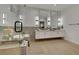 Well-lit bathroom showcasing a glass shower, soaking tub with caddy, and double sink vanity at 2621 Spalding Dr, Las Vegas, NV 89134