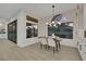 Bright dining area with large windows, modern chandelier, and stylish furniture, connecting indoor living with outdoor scenery at 2621 Spalding Dr, Las Vegas, NV 89134